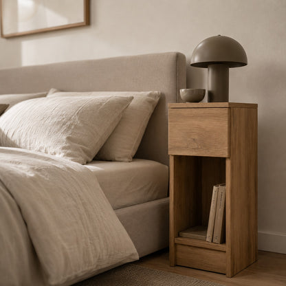 Gros plan sur une table de chevet en bois haute avec tiroir pratique et niche de rangement ouverte.