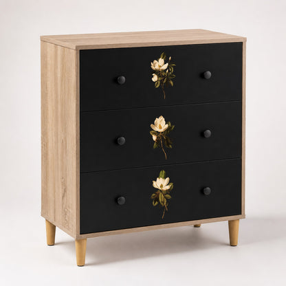 Commode 3 tiroirs Celia noire et bois clair, commode design ornée de délicats motifs floraux sur les façades.