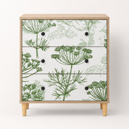 Commode design Dalia vue de face avec 3 tiroirs, motifs végétaux verts et pieds en bois clair.
