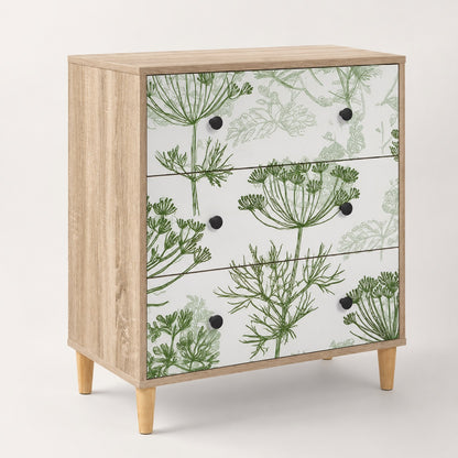 Commode 3 tiroirs Dalia au design floral vert, structure effet bois clair et poignées noires.