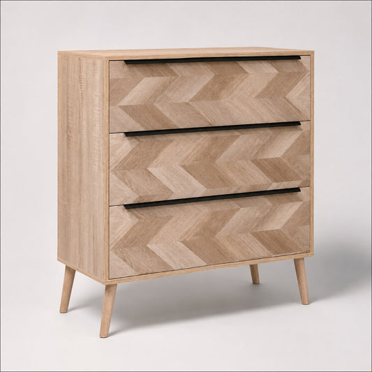 Commode 3 tiroirs design en bois clair, façades graphiques et longues poignées noires au style contemporain.
