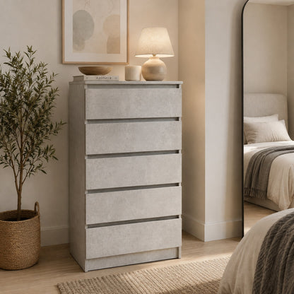 Commode 5 tiroirs finition gris béton dans une chambre moderne, alternative élégante à la commode blanche.